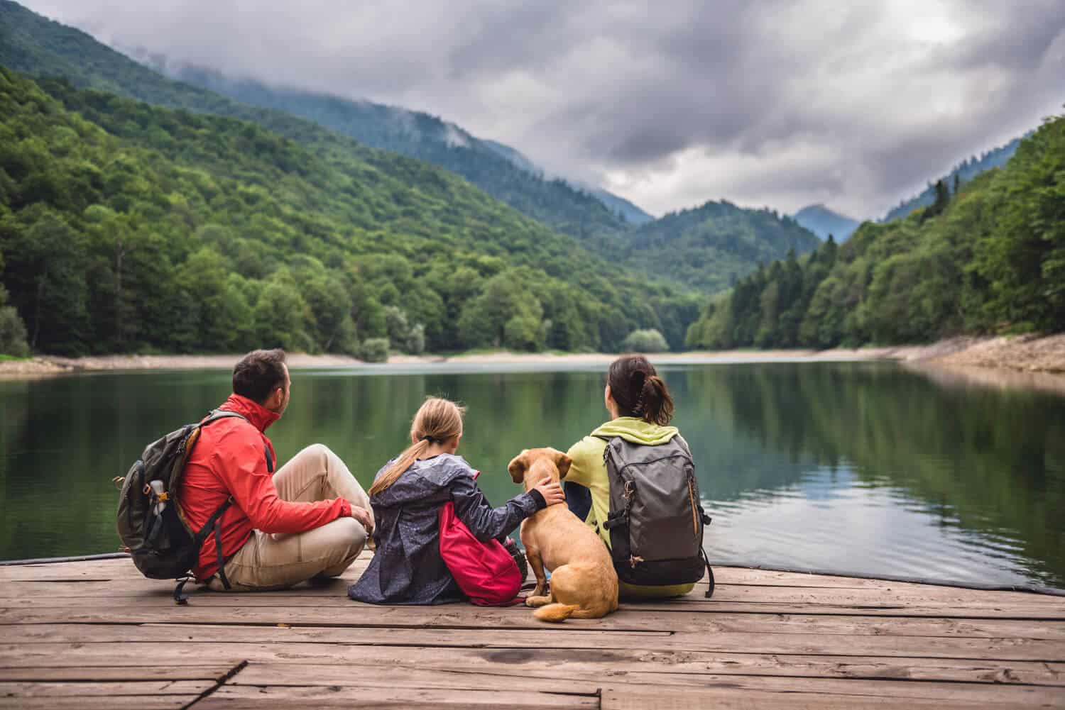 Family of three with a dog looking at a lake two people on hiking trails near Coppercrest, all age, mobile homes for sale layton coppercrest-residents-in-layton-ut-8